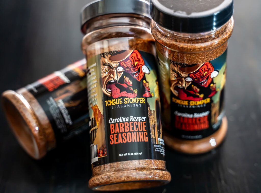 Tongue Stomper grill seasonings in Original and Carolina Reaper varieties, perfect for proteins, grilled vegetables, and even Bloody Marys.